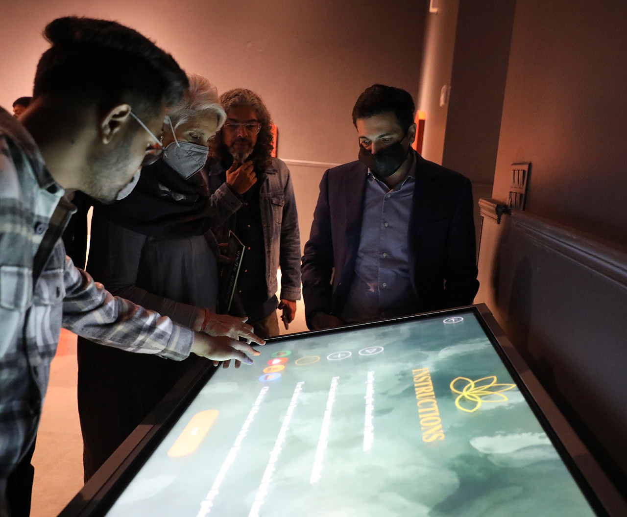 IIAD-The-Buddha-Gallery-has-two-touch-screen-tables,-a-digital-flipbook,-a-slidable-touch-screen-on-the-life-and-teachings-of-Buddha-and-a-digital-interactive-pond