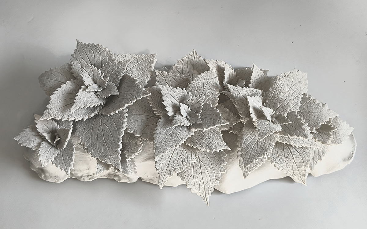 Prutha-Jain,-Holding-Coleus,-2025,-Porcelain,-15-x-8-x-6-Inches
